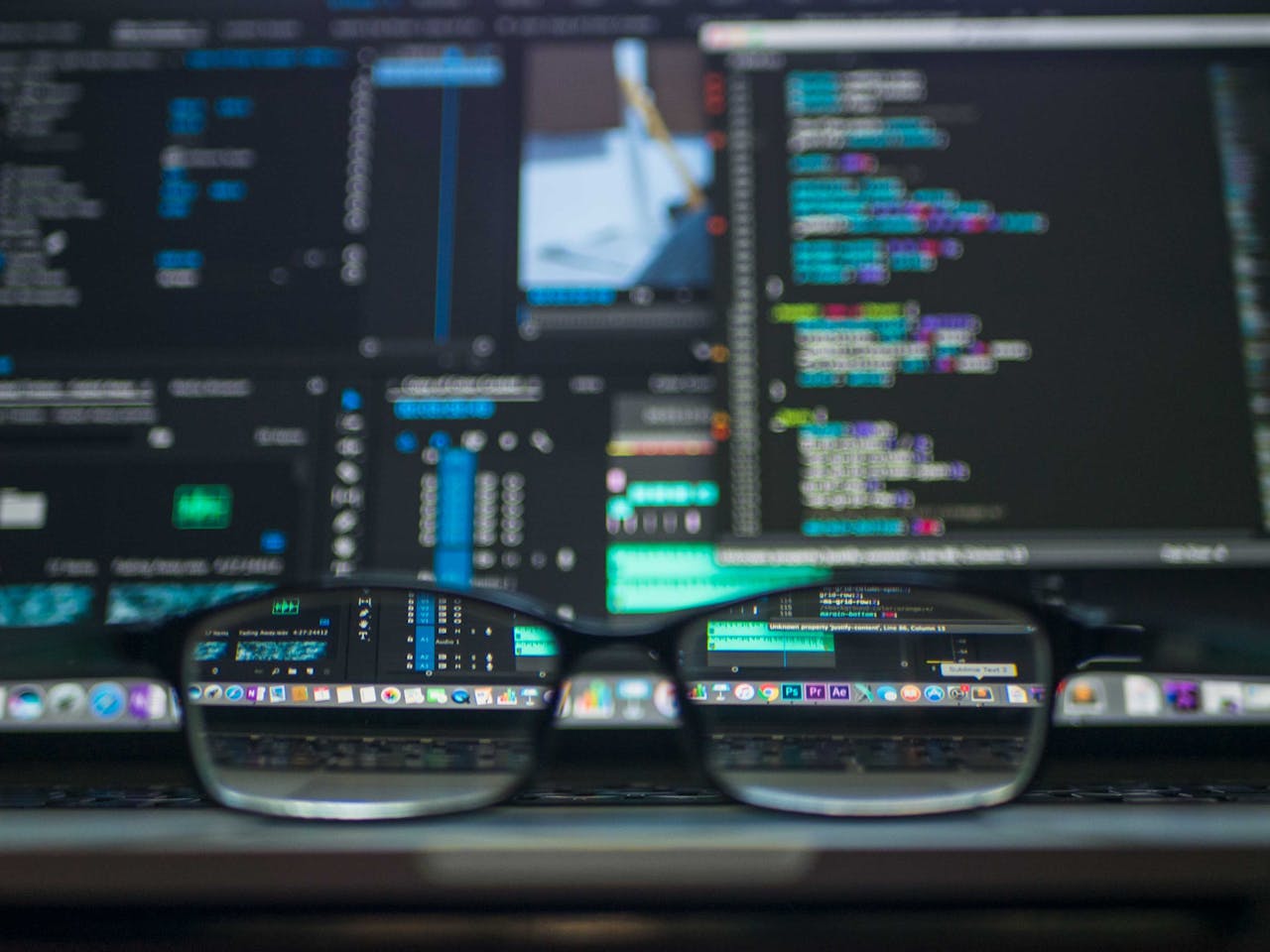 services-03 Eyeglasses reflecting computer code on a monitor, ideal for technology and programming themes.